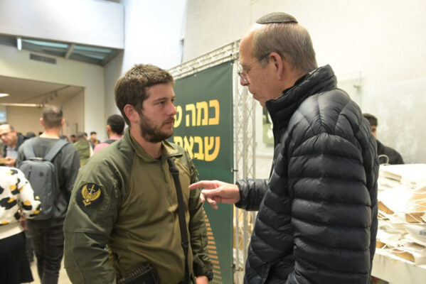 bar Ilan president talking to soldier-student