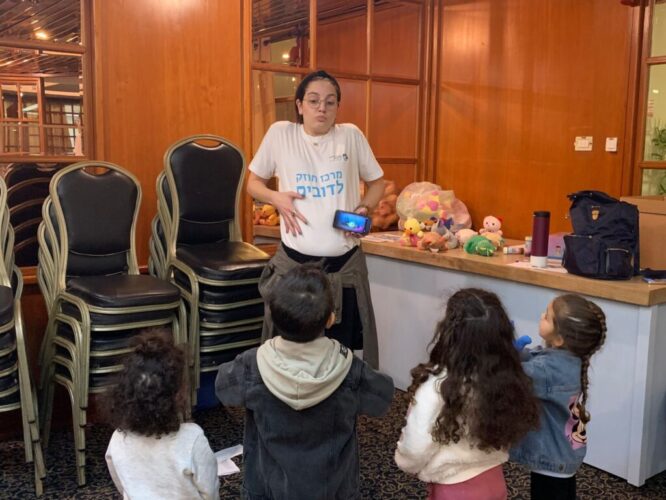 Female student doing Breathing Exercise with kids