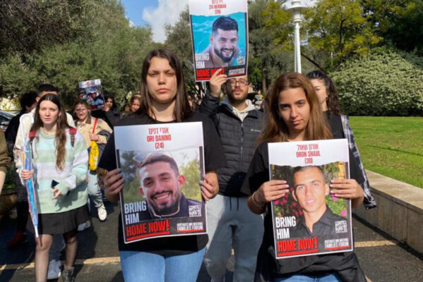 students walking holding signs on march