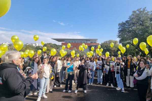 Hostage Speaker to group of students that holding yellow balloons