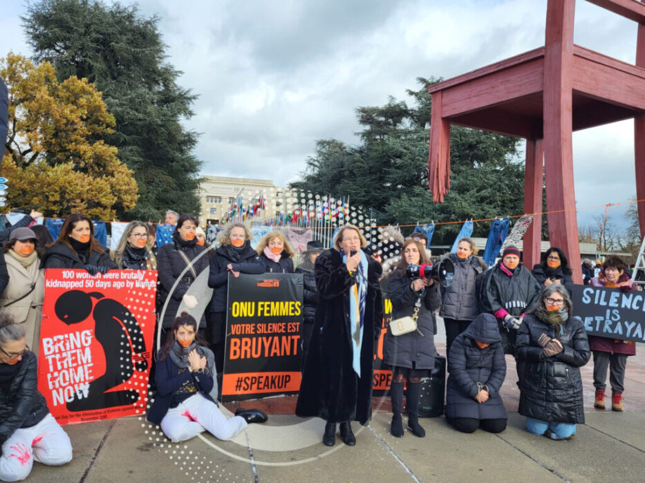 Prof. Ruth Halperin-Kaddari in march on Geneva standing with other women, their mouth is closed with masking tape, they are holding signs