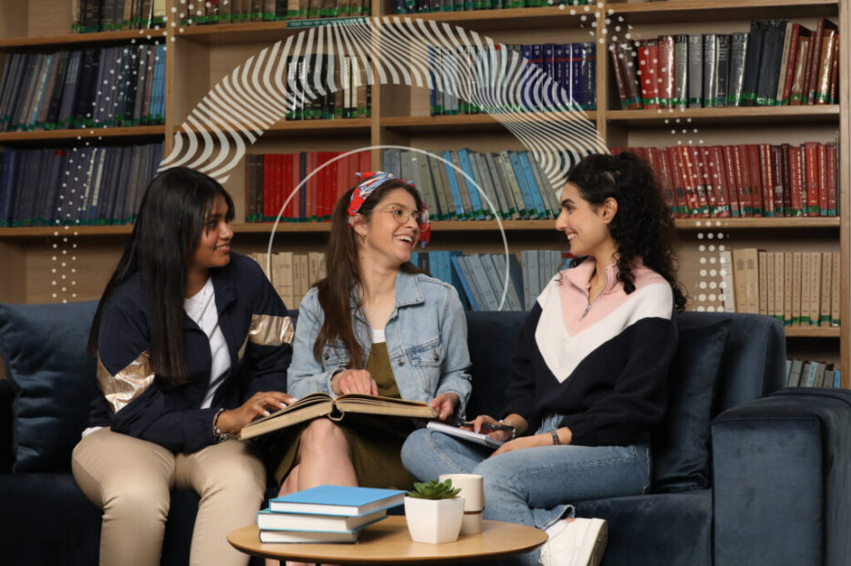 three Diverse Female Students learning holding a book